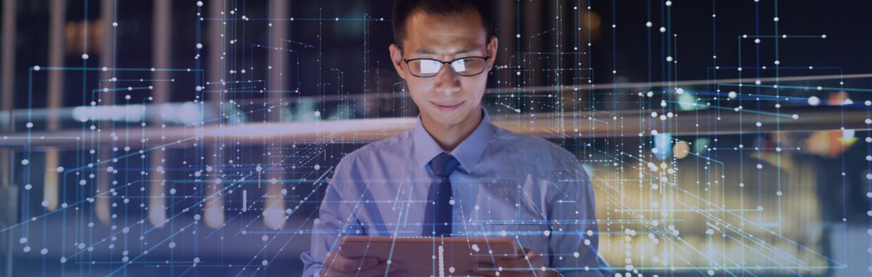 A man in a dress shirt and tie, wearing glasses, focuses on a tablet device. Digital data visualizations and network connections are overlaid in the background, suggesting a technology or data analysis theme.