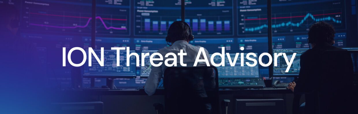 Two individuals monitoring data on multiple screens in a control room. The screens display various graphs and analytics, with the words "ION Threat Advisory" overlaid in white.