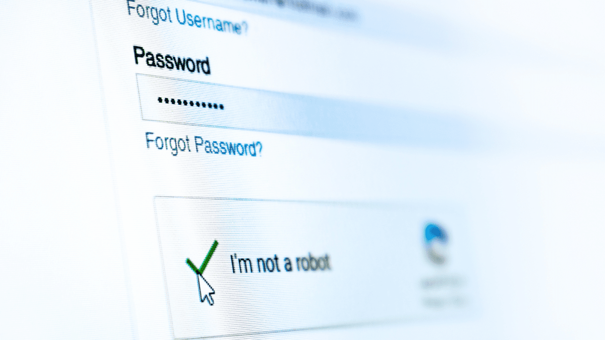 A close-up of a computer screen displaying a password entry field and a checkbox labeled 'I'm not a robot,' indicating a login process. The background is softly blurred, enhancing focus on the input areas. This image relates to Cyber Awareness: LummaC2 Malware.