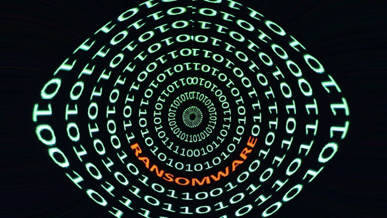 A digital spiral made up of binary code with the word 'RANSOMWARE' in orange, emphasizing the concept of cybersecurity threats associated with the Inside Lockbit Ransomware Gang.
