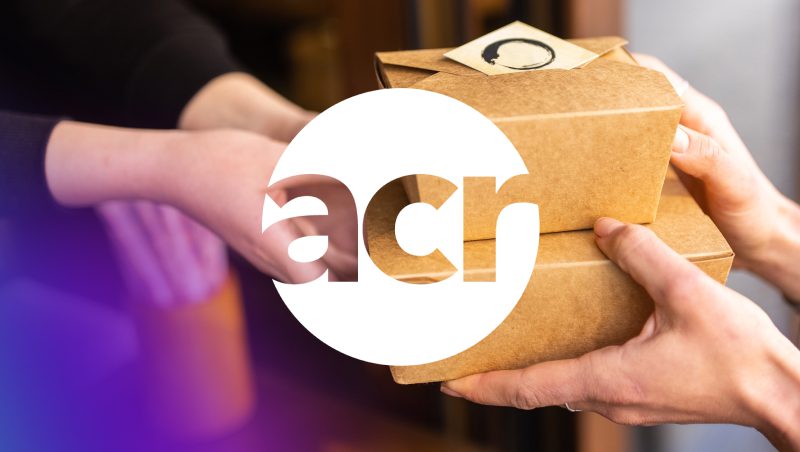 A pair of hands exchanging two brown takeaway boxes, with a logo overlay featuring the letters 'acr.' The background has a soft gradient transition from purple to white.
