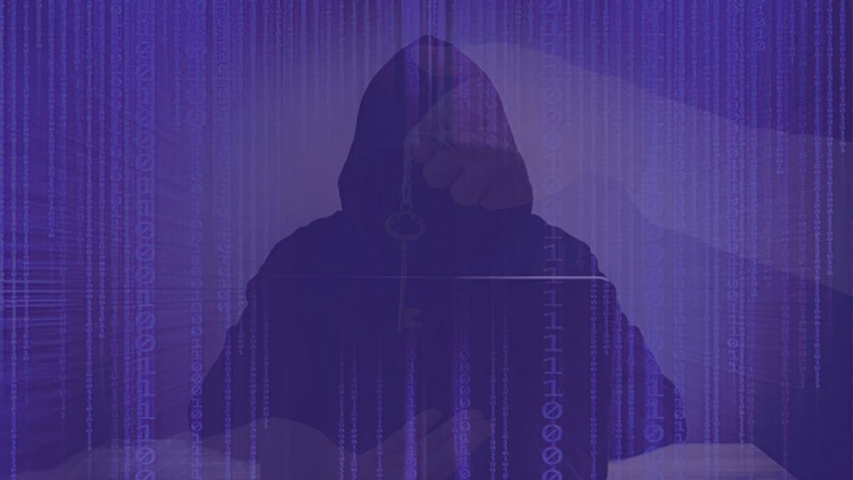 A silhouette of a hooded figure sitting in front of a laptop, with binary code in the background. The figure's hand appears to be holding a key, representing themes of hacking and cybersecurity.