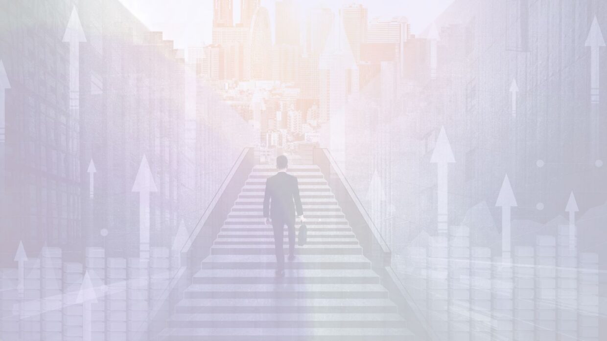 A man in a suit stands on a staircase heading upward towards a city skyline. The background features abstract upward arrows and bar graphs, suggesting growth and progress in a business context.